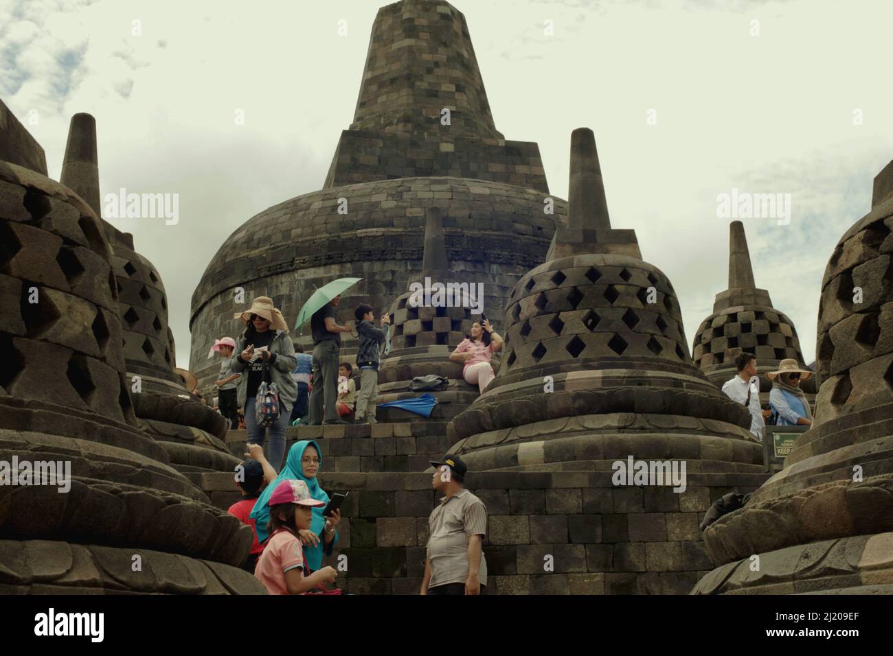 Visitors having recreational time at Borobudur temple in Magelang, Central Java, Indonesia. Borobudur was constructed by Sailendra Dynasty, the same dynasty who ruled Srivijaya kingdom since at least 8th century. Stock Photo