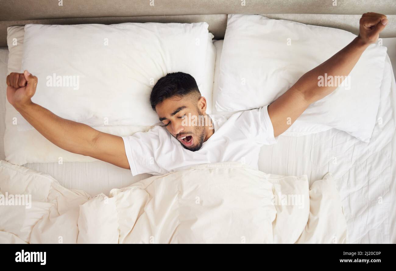 My pillow gives me a new hairstyle every morning. Shot of a young man waking up in a bed at home
