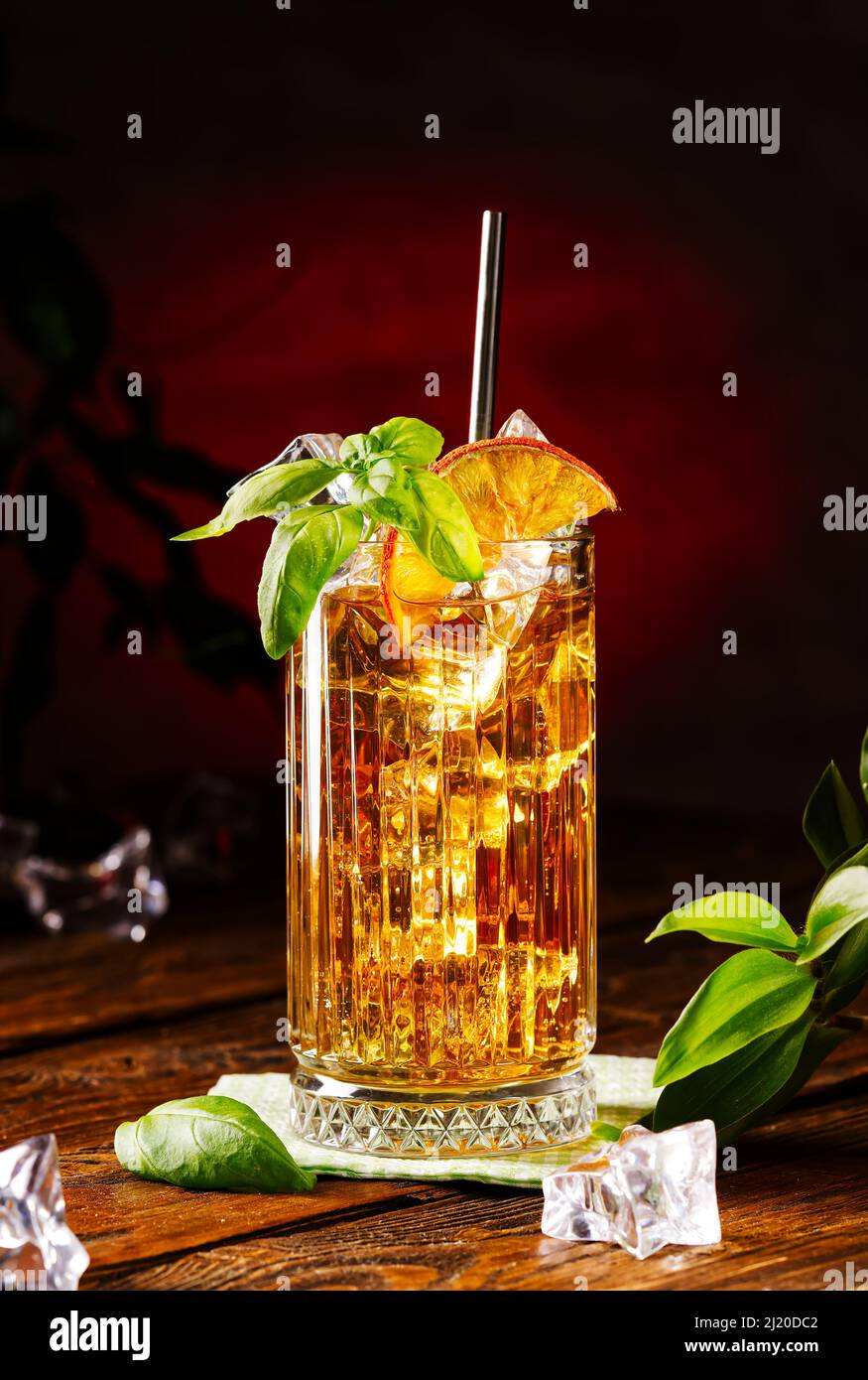 Glass of long island ice tea cocktail decorated with mint. Cuba Libre low key Stock Photo
