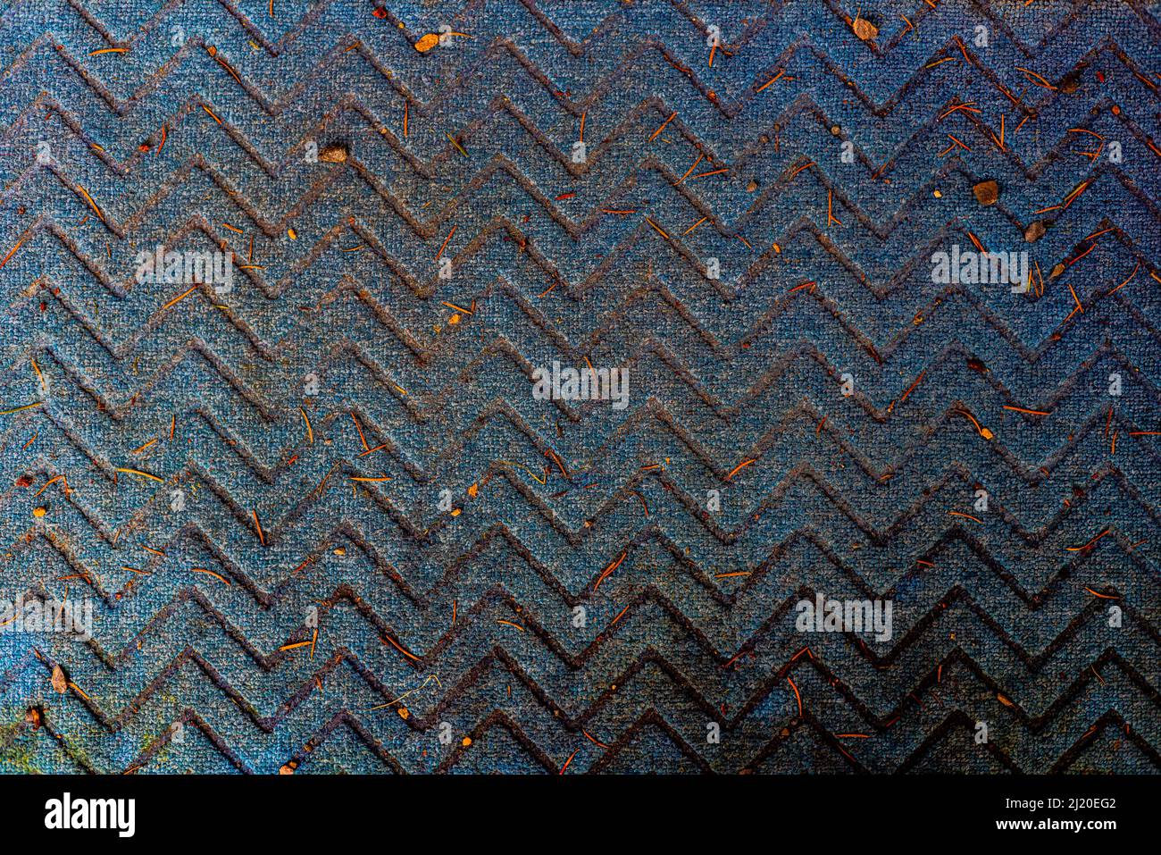 Up down pattern on blue carpet texture that is very dirty. Stock Photo