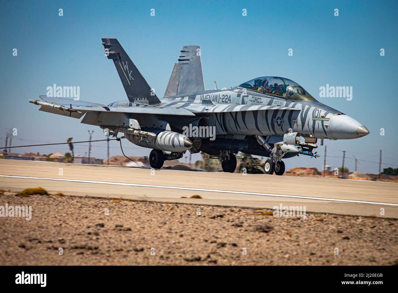 A U.S. Marine Corps F/A-18 Hornet latches onto an emergency arresting gear system, during an exercise as part of Weapons and Tactics Instructor (WTI) course 2-22, at Marine Corps Air Station Yuma, Arizona, March 24, 2022. WTI is a seven-week training event hosted by MAWTS-1, providing standardized advanced tactical training and certification of unit instructor qualifications to support Marine aviation training and readiness, and assists in developing and employing aviation weapons and tactics. (U.S. Marine Corps photo by Lance Cpl. Symira Bostic) Stock Photo