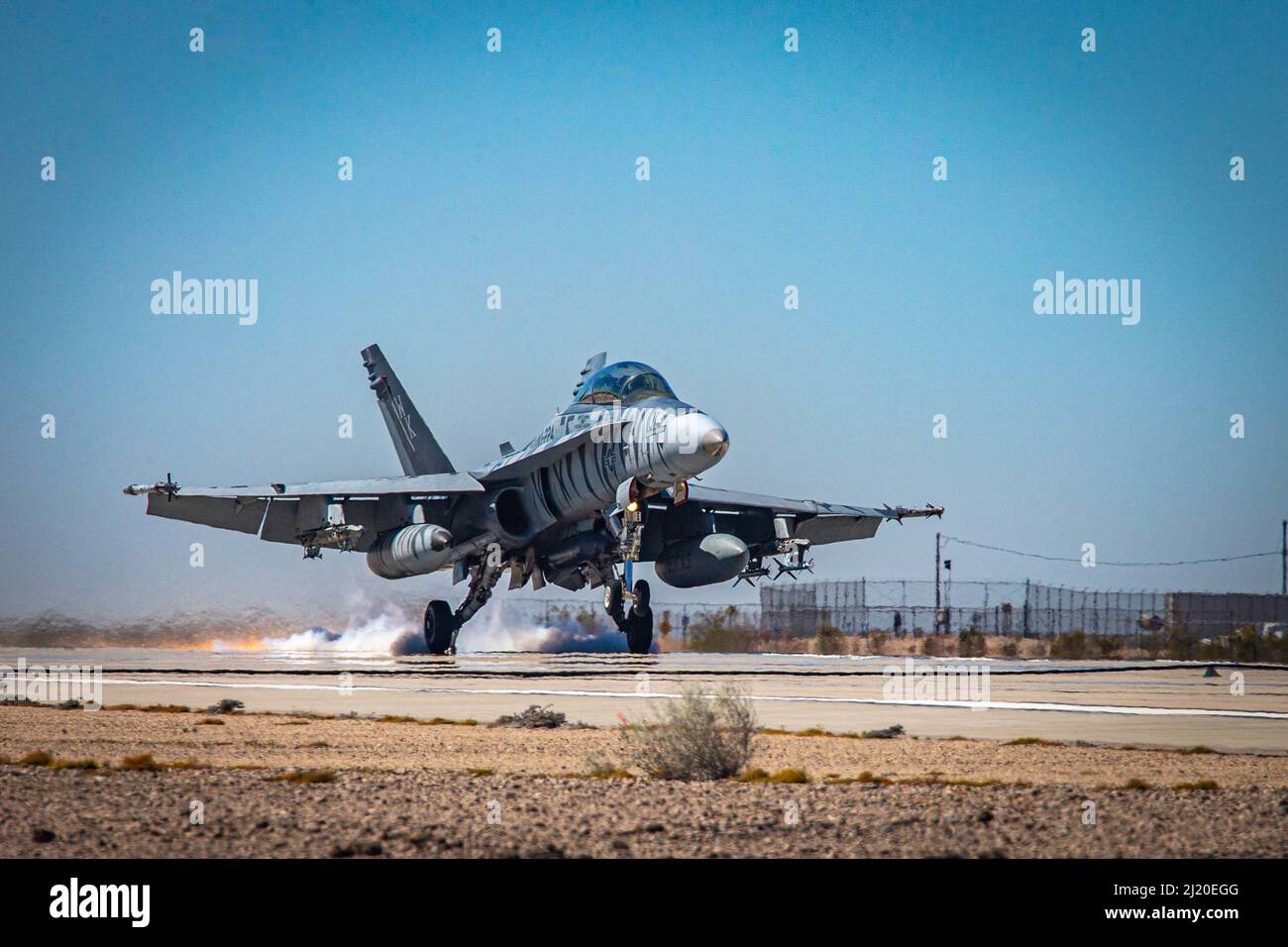 A U.S. Marine Corps F/A-18 Hornet conducts a mock emergency landing, during an emergency arresting exercise during the Weapons and Tactics Instructor (WTI) course 2-22, at Marine Corps Air Station Yuma, Arizona, March 24, 2022. WTI is a seven-week training event hosted by MAWTS-1, providing standardized advanced tactical training and certification of unit instructor qualifications to support Marine aviation training and readiness, and assists in developing and employing aviation weapons and tactics. (U.S. Marine Corps photo by Lance Cpl. Symira Bostic) Stock Photo