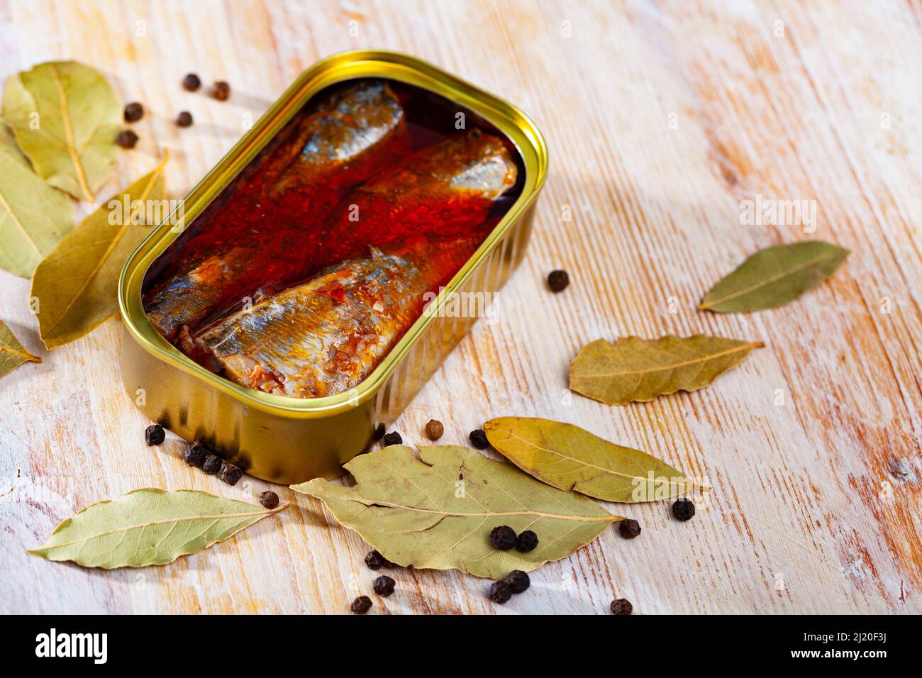 Canned sea fish, mackerel fillets in tomato served with peppers and bay