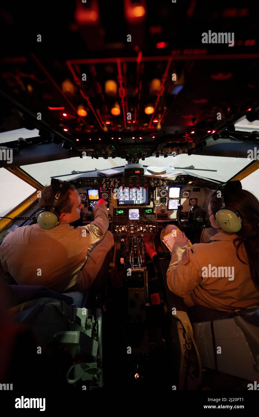 U.S. Air Force Capt. Carl Burnham (left) and 1st Lt. Stephanie Staples (right), KC-135 Stratotanker pilots assigned to the 340th Expeditionary Air Refueling Squadron, conduct pre-flight checks at Al Udeid Air Base, Qatar, March 12, 2022. The 340th EARS, deployed with with Ninth Air Force (Air Forces Central), is responsible for delivering fuel to U.S. and coalition forces, enabling war-winning air power, deterrence and stability to the region. (U.S. Air Force photo by Tech. Sgt. Christopher Ruano) Stock Photo