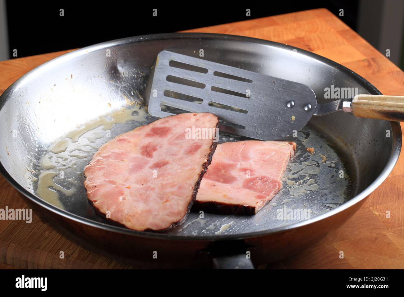 Frying Slices of Ham on Cooking Pan Stock Photo Alamy