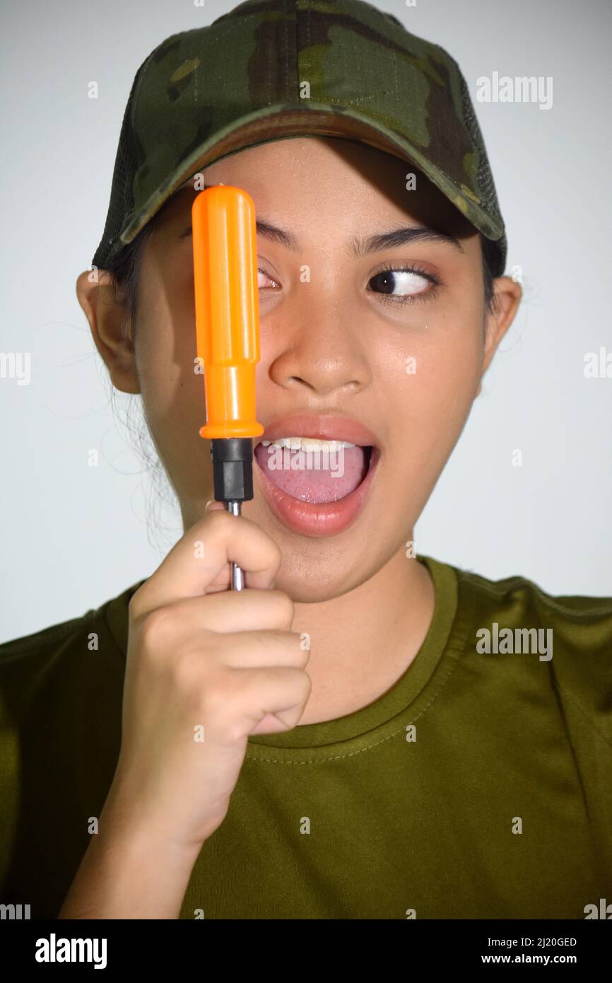 A Funny Female Soldier With Screwdriver Stock Photo