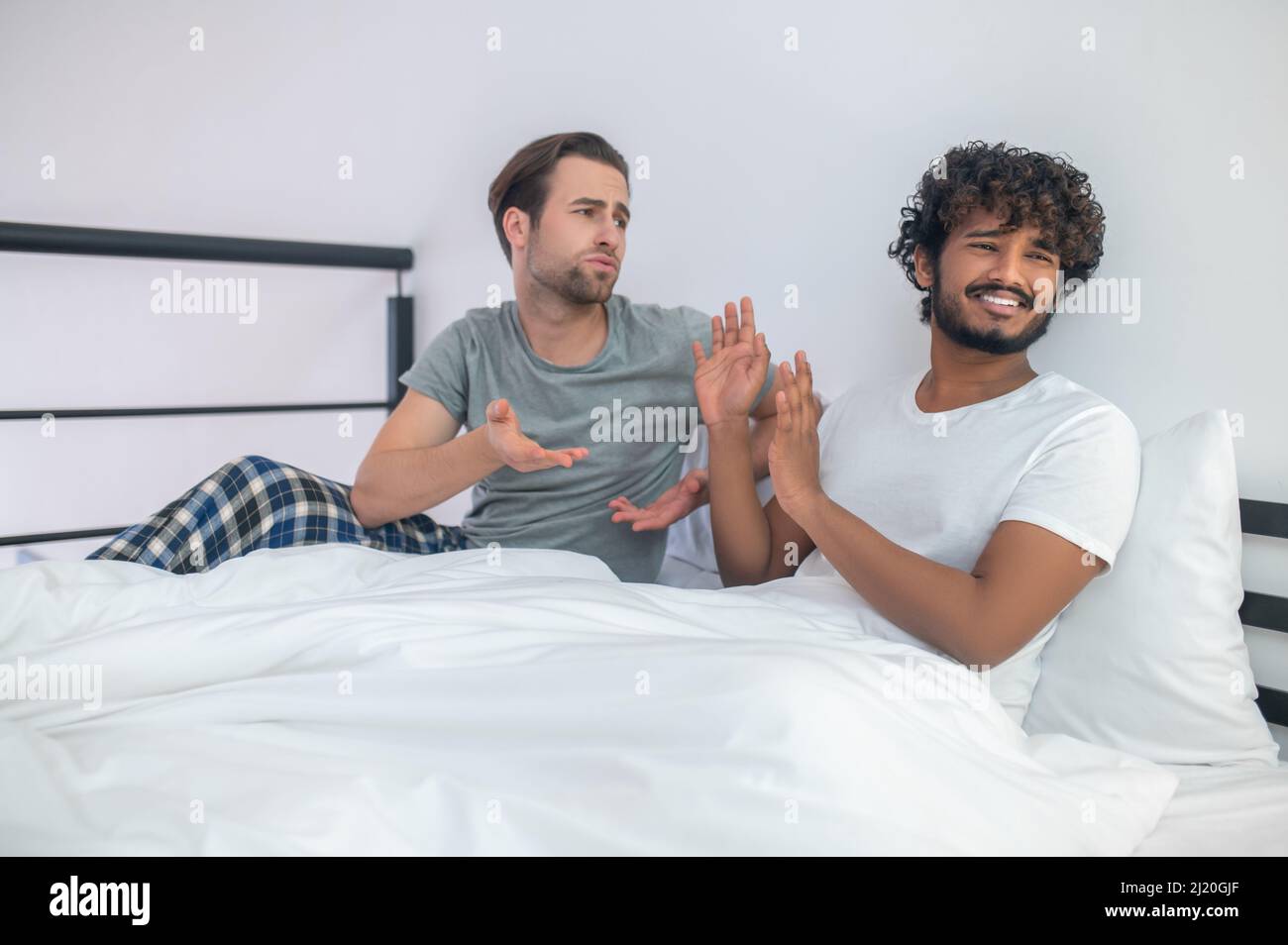 Gay couple having an argument in the bedroom Stock Photo