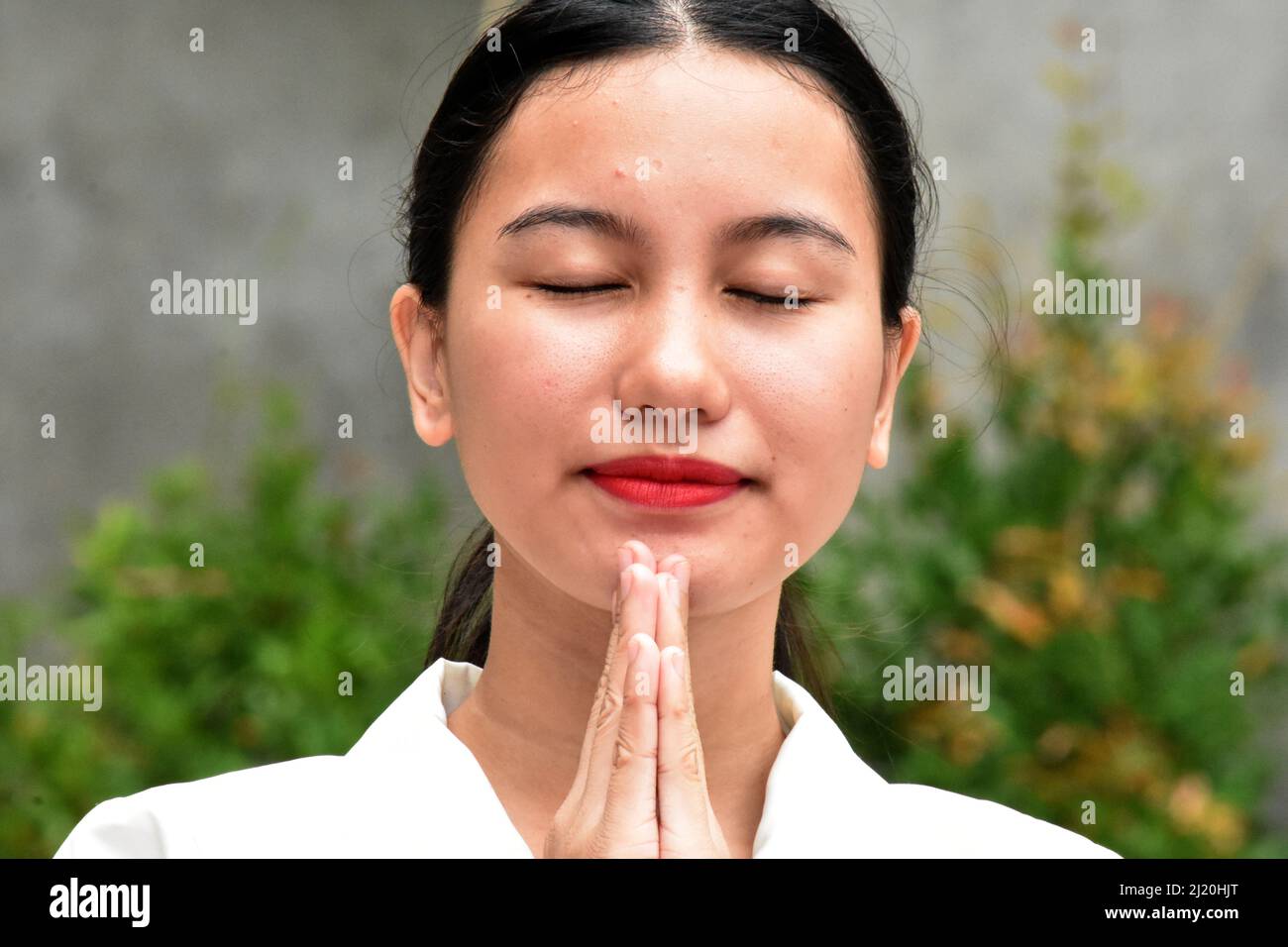 A Religious Asian Woman Praying Stock Photo
