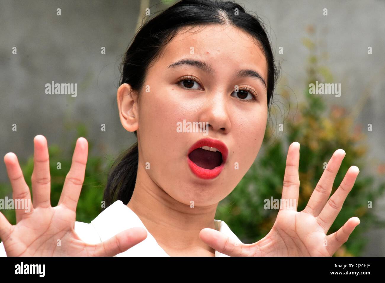 A Scared And Startled Asian Woman Stock Photo