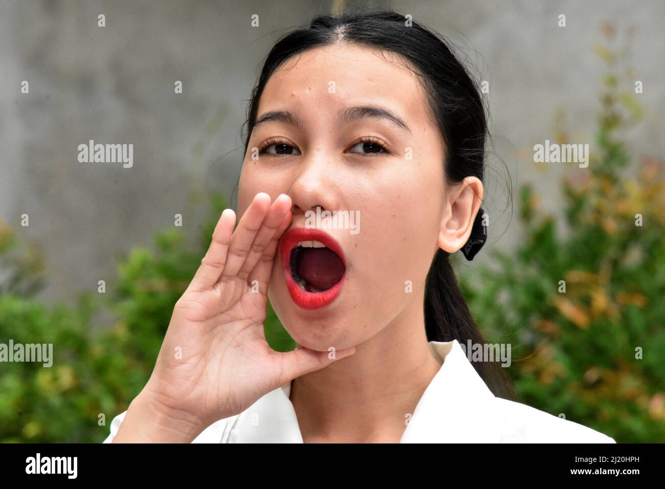 An Asian Woman Talking Or Yelling Stock Photo