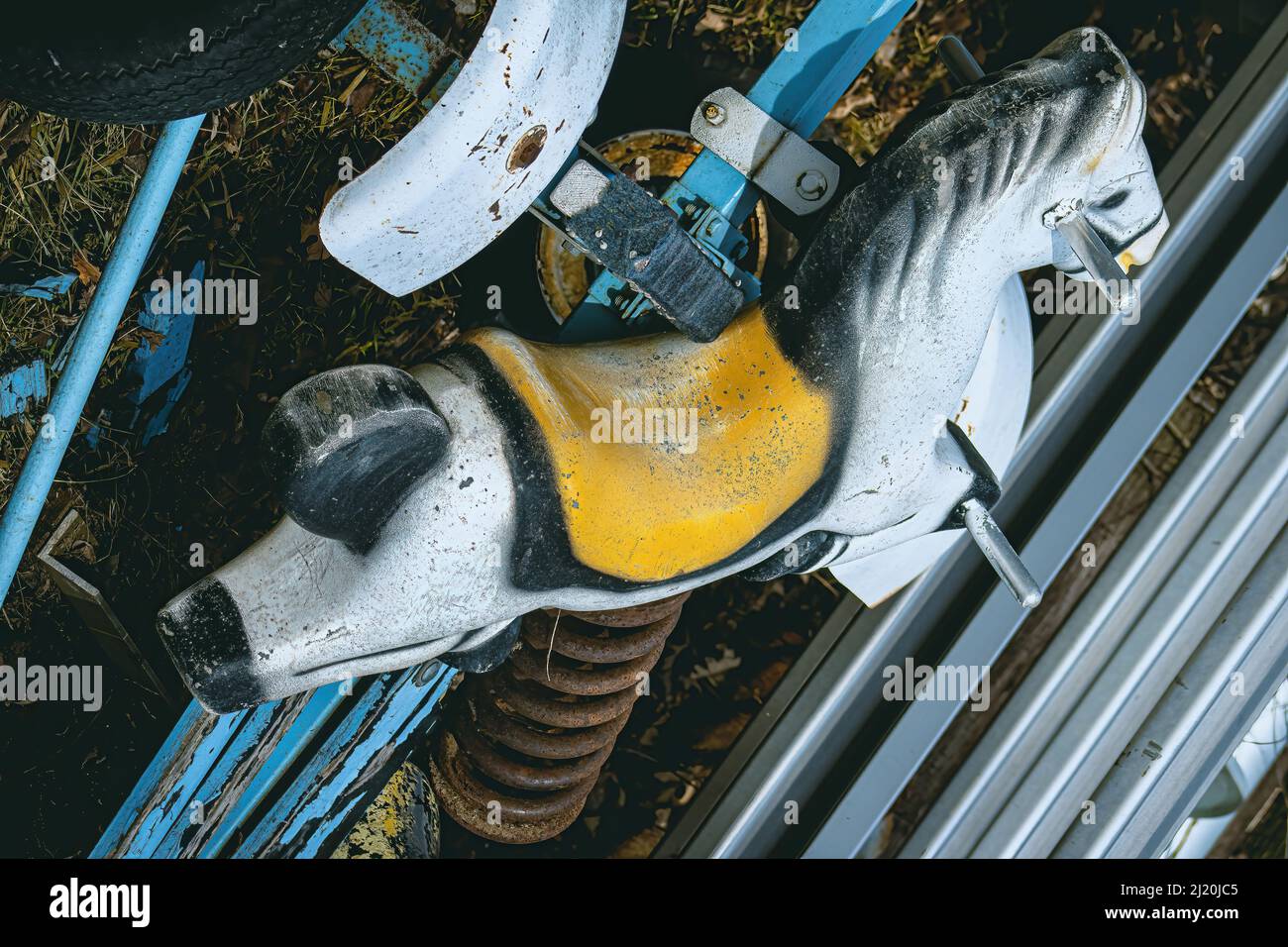 pile of trash this old swinging horse stands out Stock Photo Alamy
