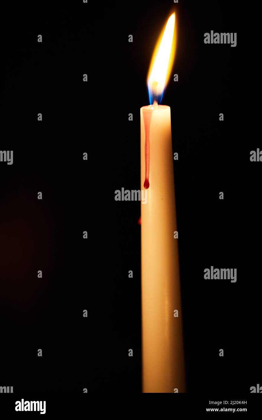 One candle burns in the dark. The concept of loneliness and selfbelief. Prayers to the Lord