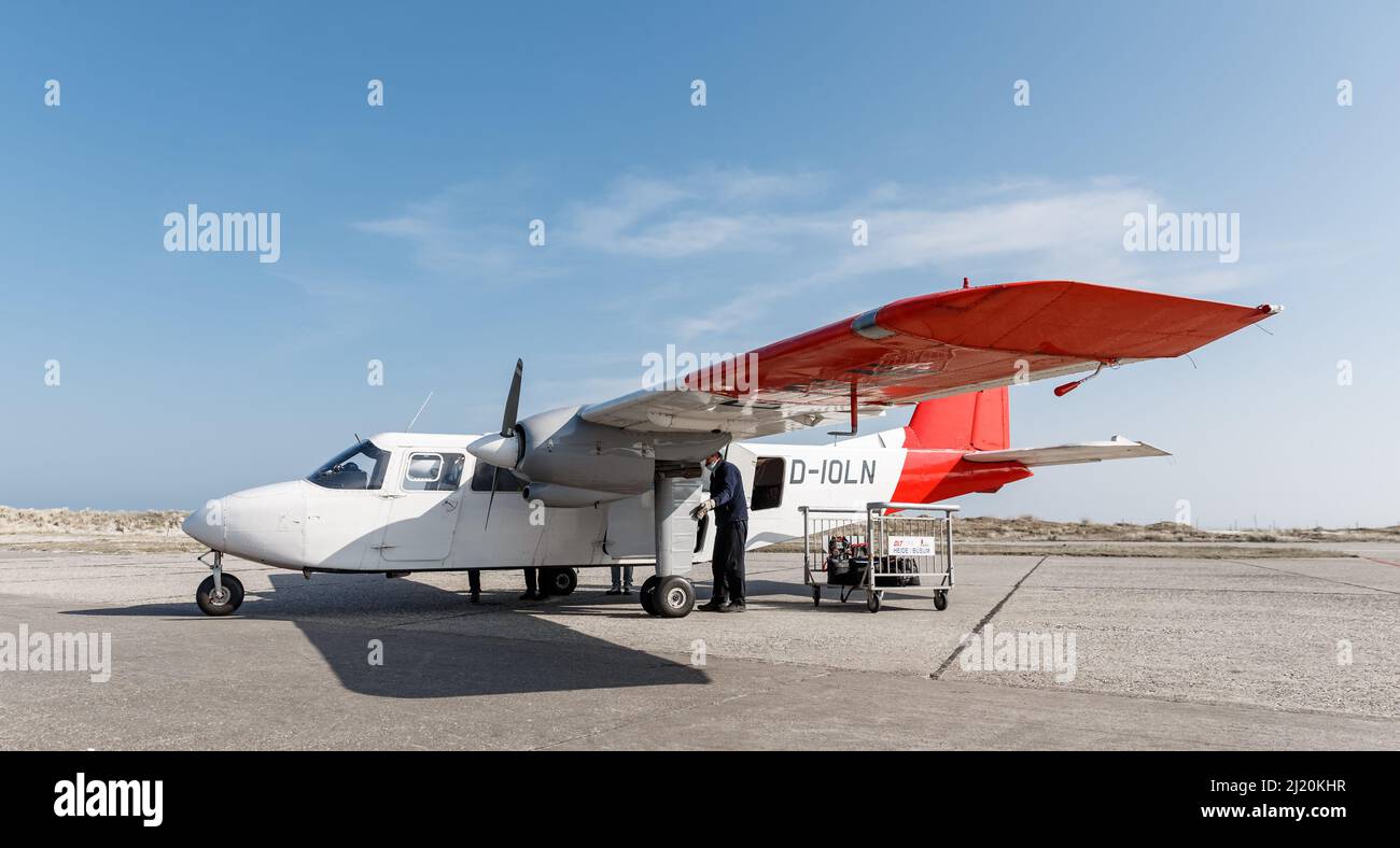 Helgoland, Germany. 25th Mar, 2022. A Britten Norman Islander with nine seats of the Ostfriesischer Flug-Dienst (OFD) is parked at the Helgoland airfield. From 01 April, an aircraft of this type will take off twice daily from Uetersen for a return flight to Helgoland. Credit: Markus Scholz/dpa/Alamy Live News Stock Photo