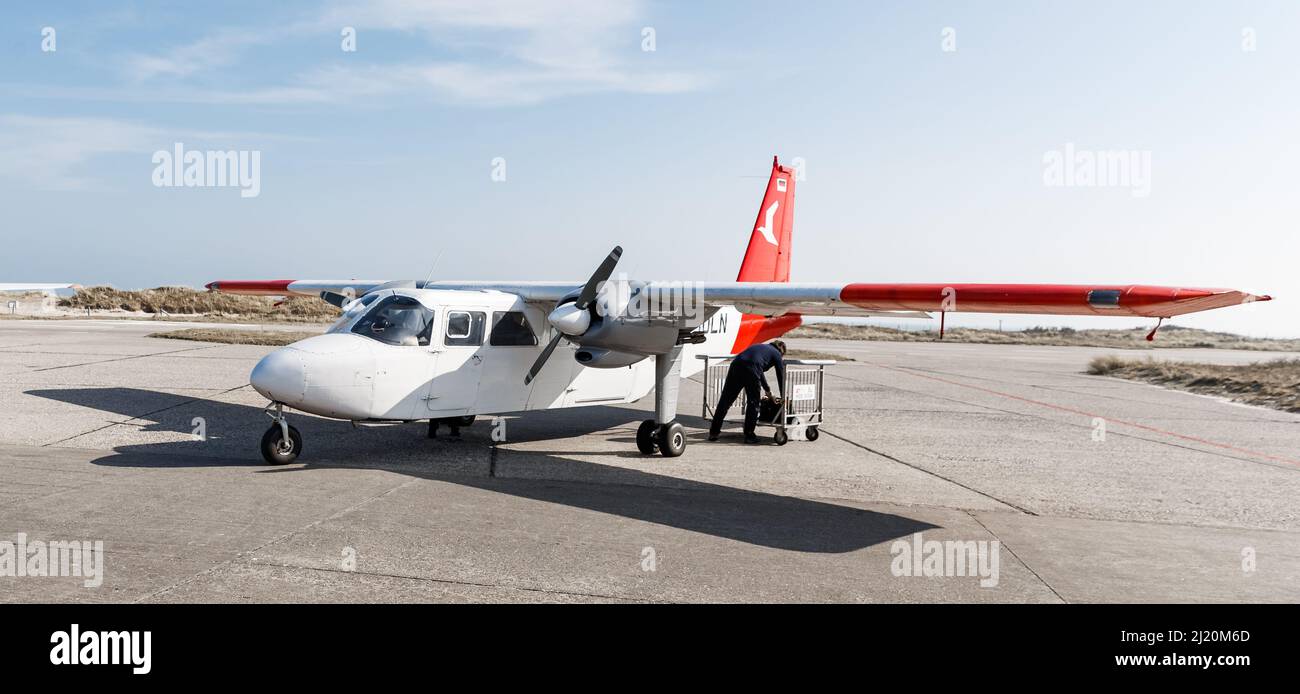 Helgoland, Germany. 25th Mar, 2022. A Britten Norman Islander with nine seats of the Ostfriesischer Flug-Dienst (OFD) is standing on the airfield of Helgoland. From April 1, an aircraft of this type will take off twice daily from Uetersen for a return flight to Helgoland. Credit: Markus Scholz/dpa/Alamy Live News Stock Photo