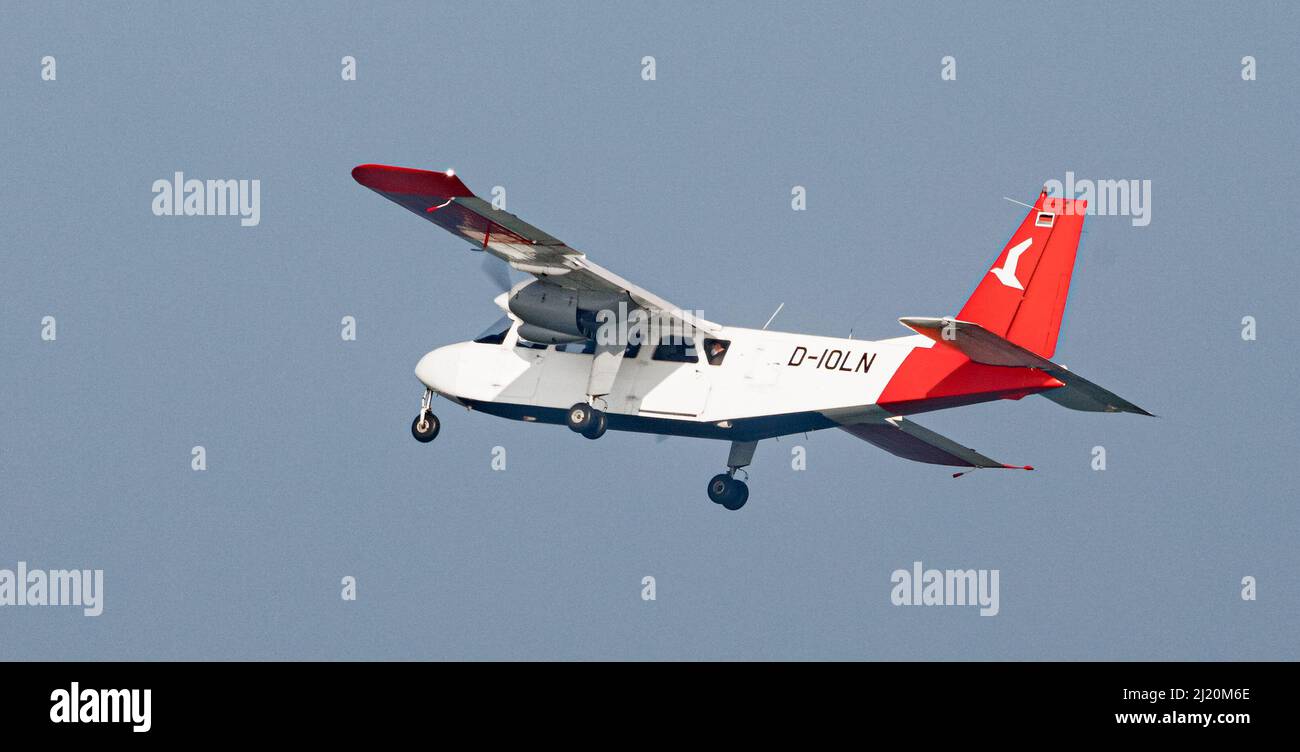 Helgoland, Germany. 25th Mar, 2022. A Britten Norman Islander with nine seats of the Ostfriesischer Flug-Dienst (OFD) flies over Helgoland.From 01.April a machine of this type takes off twice daily from Uetersen for a return flight to Helgoland. Credit: Markus Scholz/dpa/Alamy Live News Stock Photo