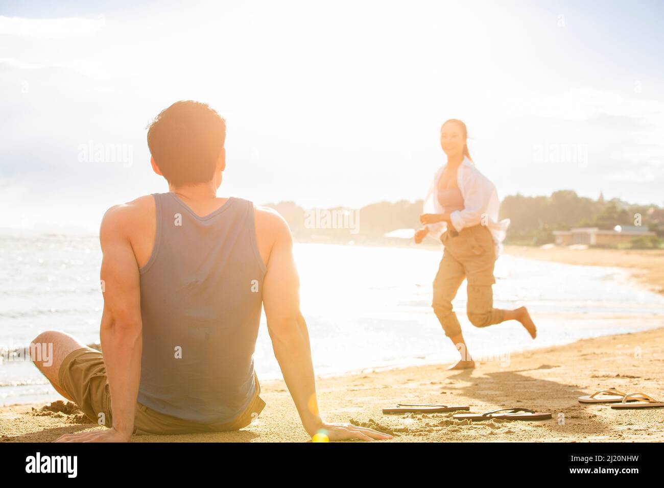 Man watching woman on beach hi-res stock photography and images - Alamy