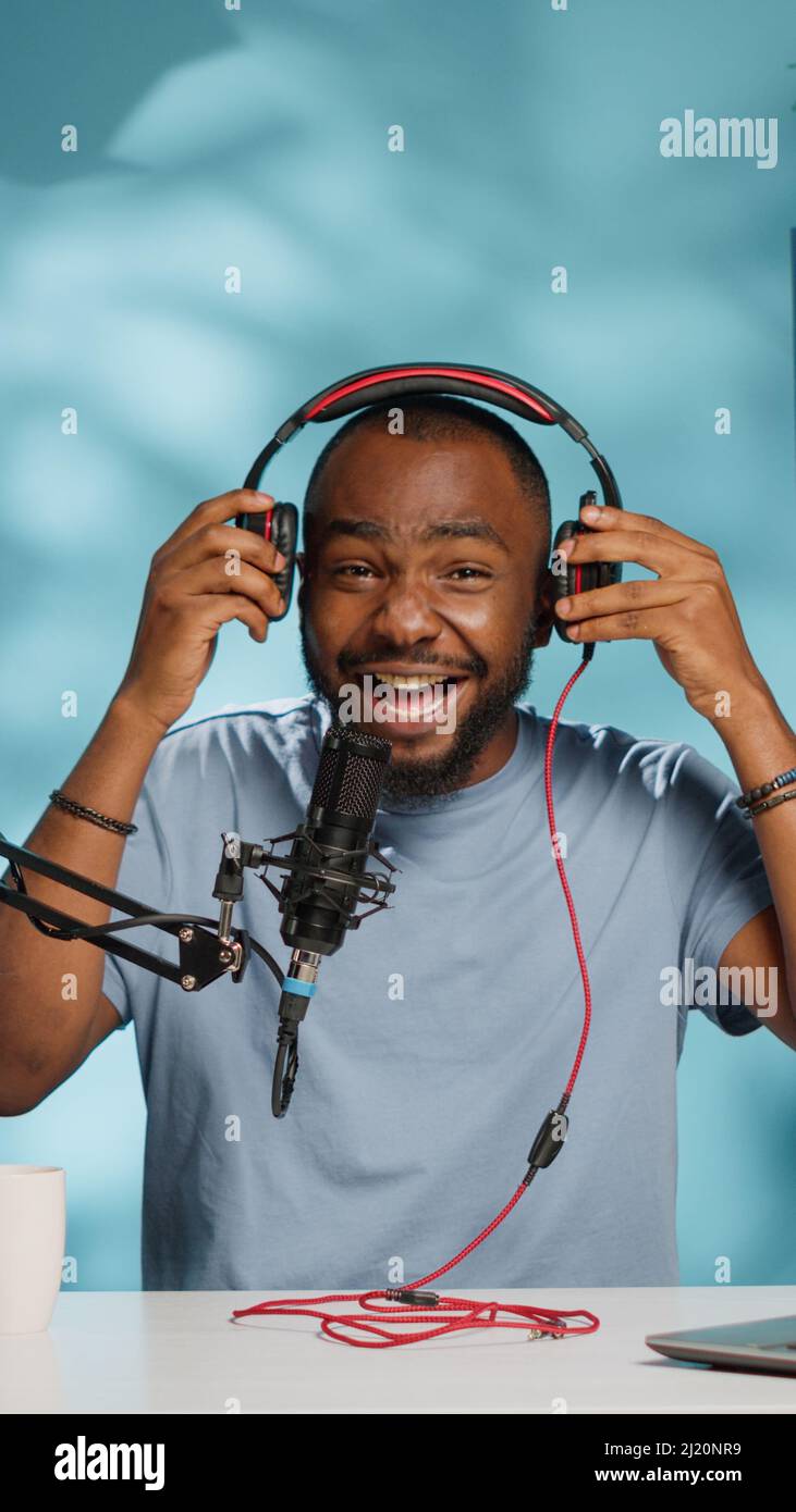 Blogger testing headphones for product review on camera in studio