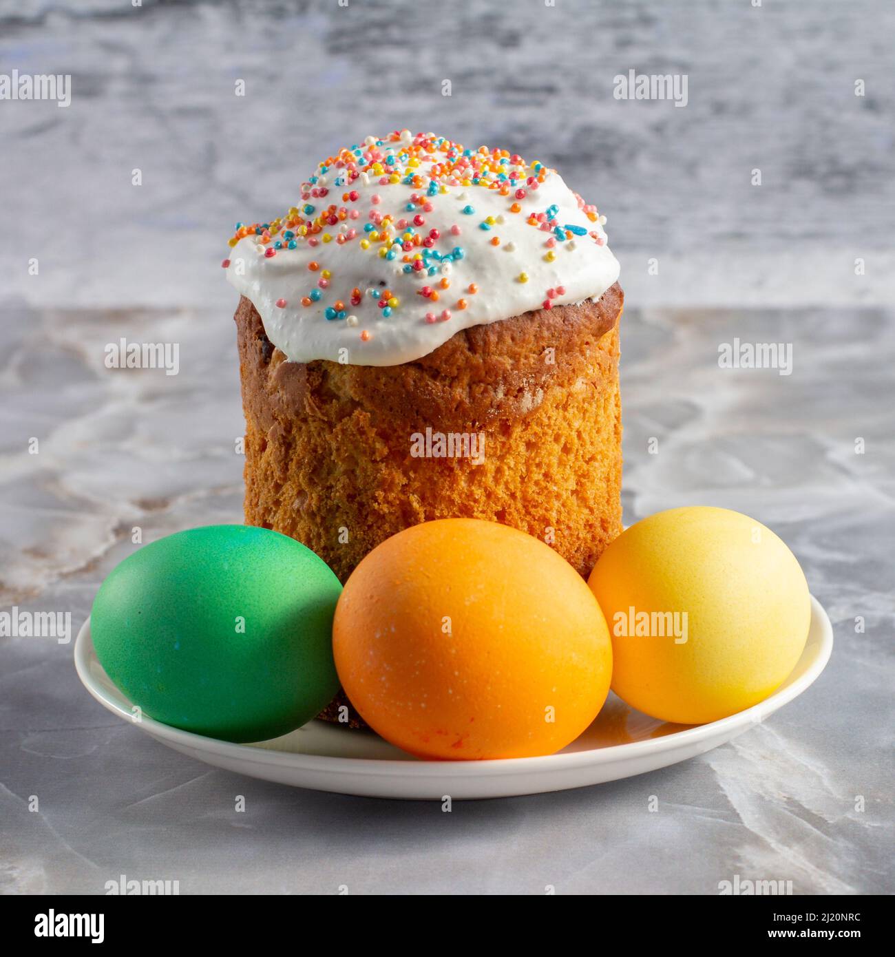 Easter cake and colorful Easter eggs on the plate. Traditional orthodox christian easter food. Stock Photo