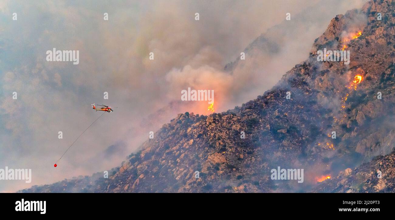 Lightning caused fire on Mount Lemmon, Forest Service Fire suppression Wildland Firefighters use helicopters to 'bomb' the hot spots to control the sp Stock Photo