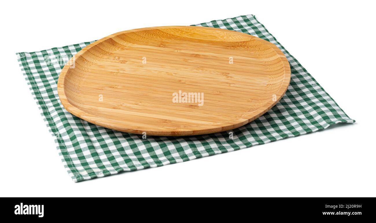 Wooden plate and tablecloth on white background Stock Photo