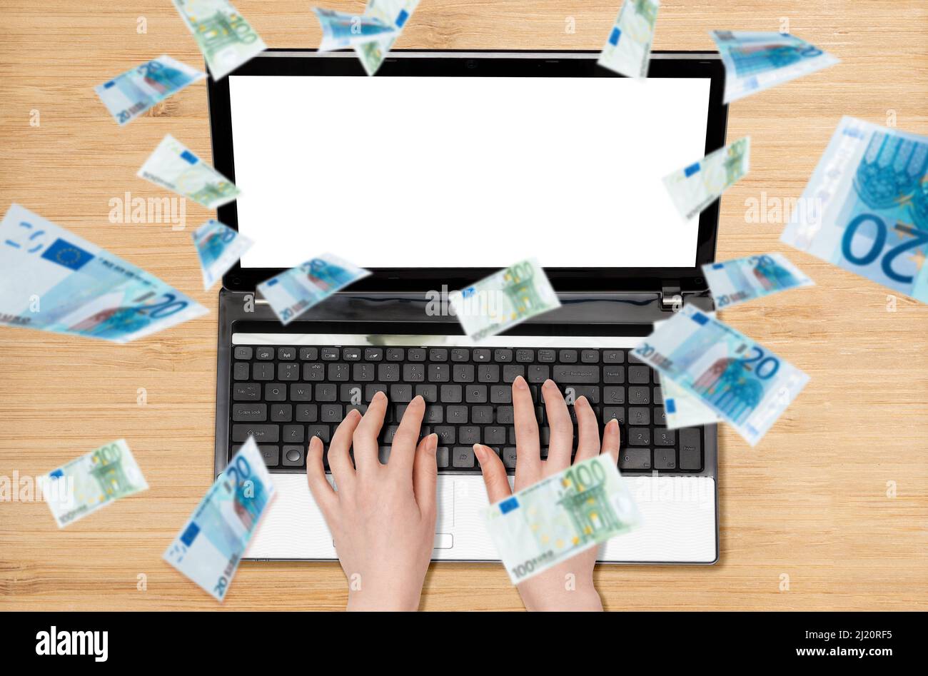 Woman's hands are typing on a laptop, euro bills are pouring down from above. Flat lay. The concept of crisis and investment. Stock Photo