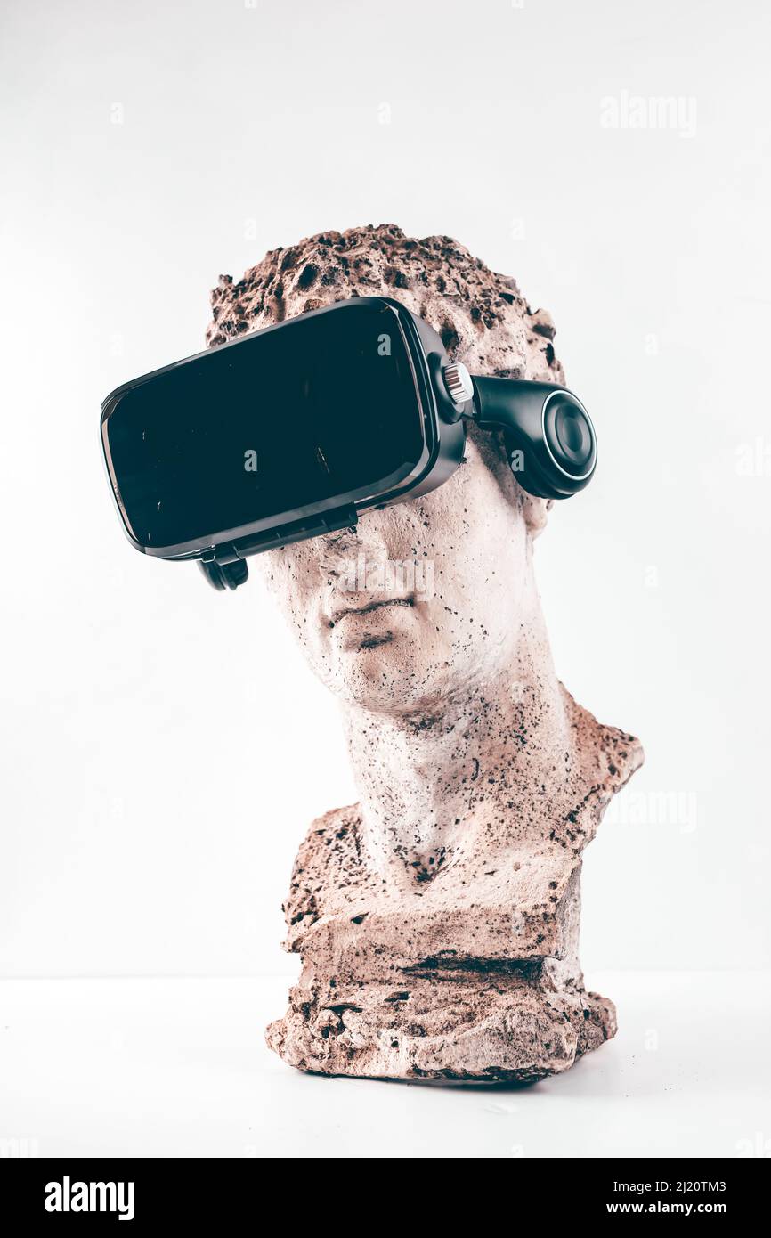 Ancient statue with VR glasses on white background. Concept of art and Virtual Reality. Stock Photo