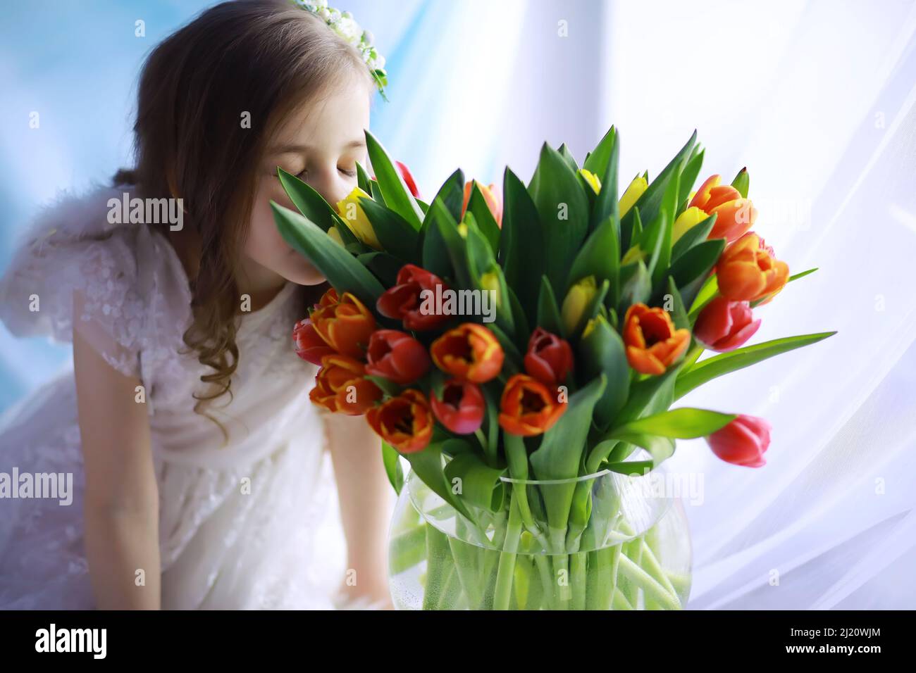 Beautiful girl in white dresses with a magnificent bouquet of first ...