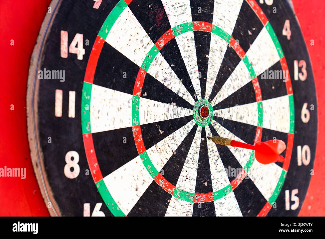 The target of the game of darts on a red background. Concept of success