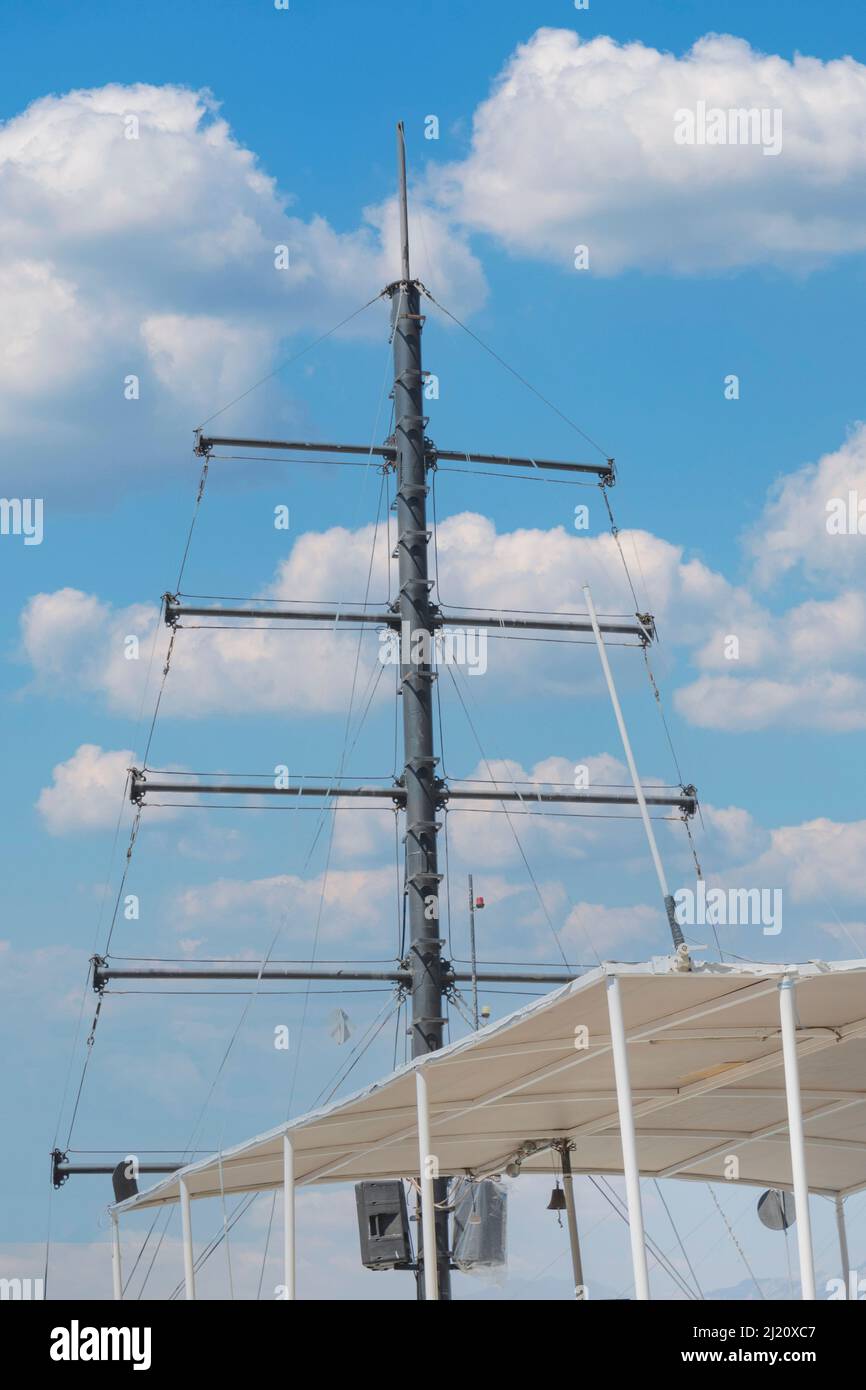 Detailed closeup of mast rigging top on sail boat during cruise, shot ...