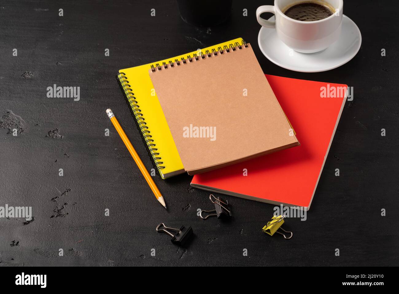 Three notepads on a black table close up Stock Photo