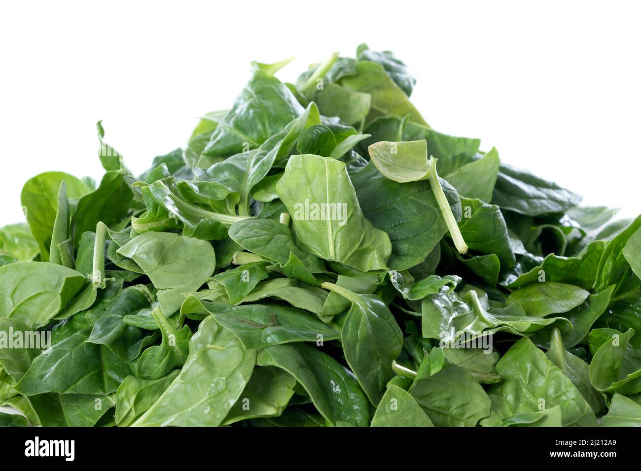 Pile of fresh green baby spinach leaves isolated on white background ...