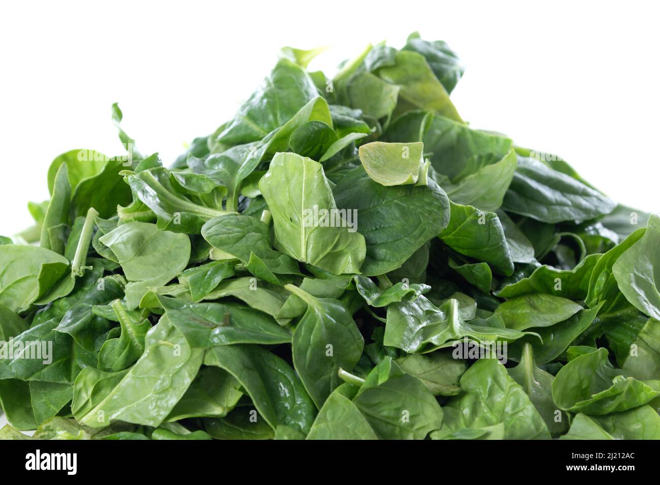Pile of fresh green baby spinach leaves isolated on white background ...