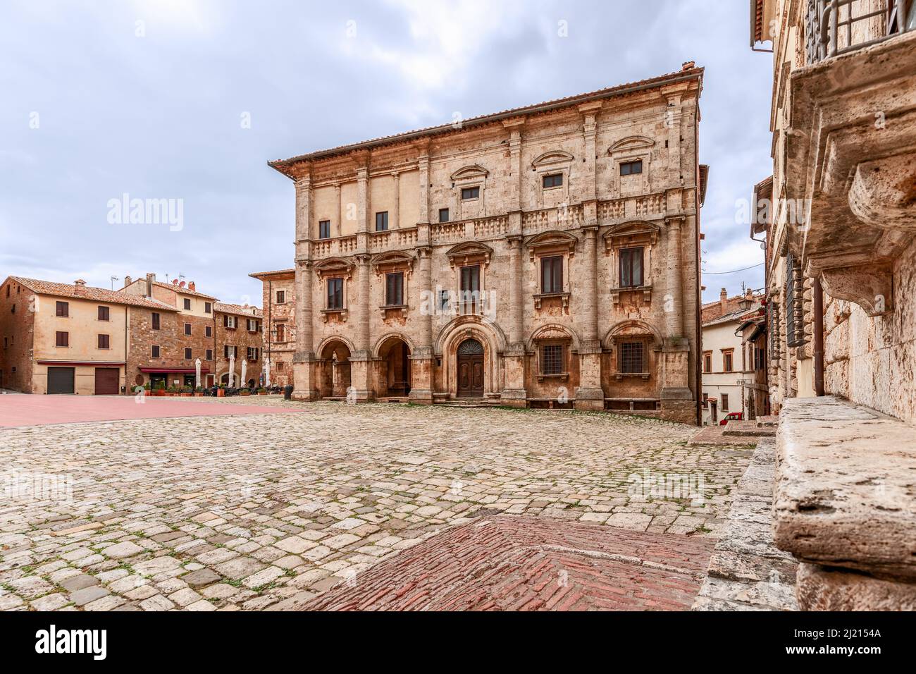 A complex of Renaissance historical buildings on the cobbled central square Piazza Grande in medieval Montepulciano town, Tuscany, Italy Stock Photo