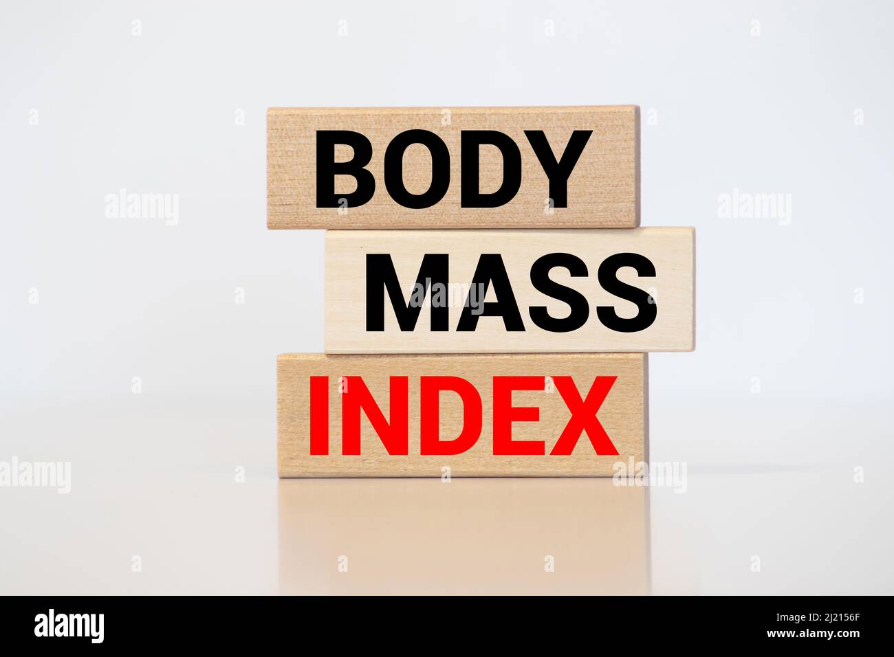 Cubes and blocks form the expression 'BMI - Body Mass Index'. Beautiful white background, copy space. Concept. Stock Photo