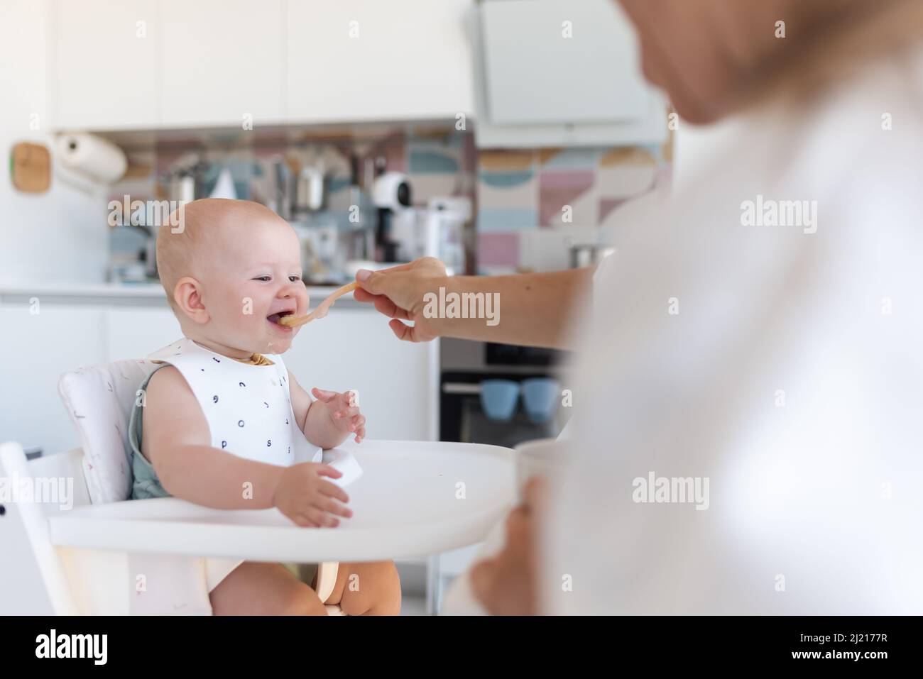 baby's first feeding, mom feeds a baby with a spoon Stock Photo Alamy