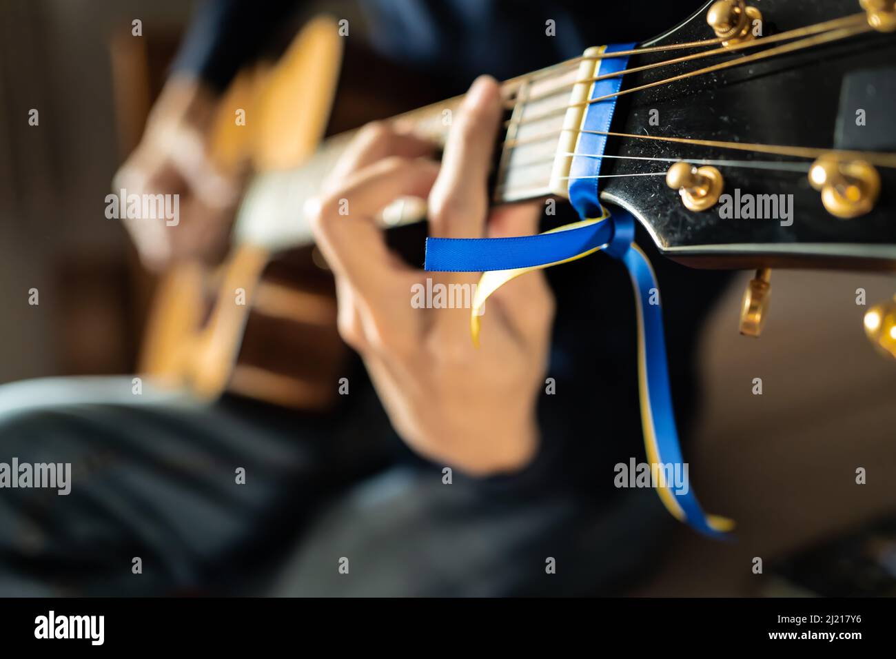 Blue and yellow ribbon for Ukraine tied on a guitar Stock Photo