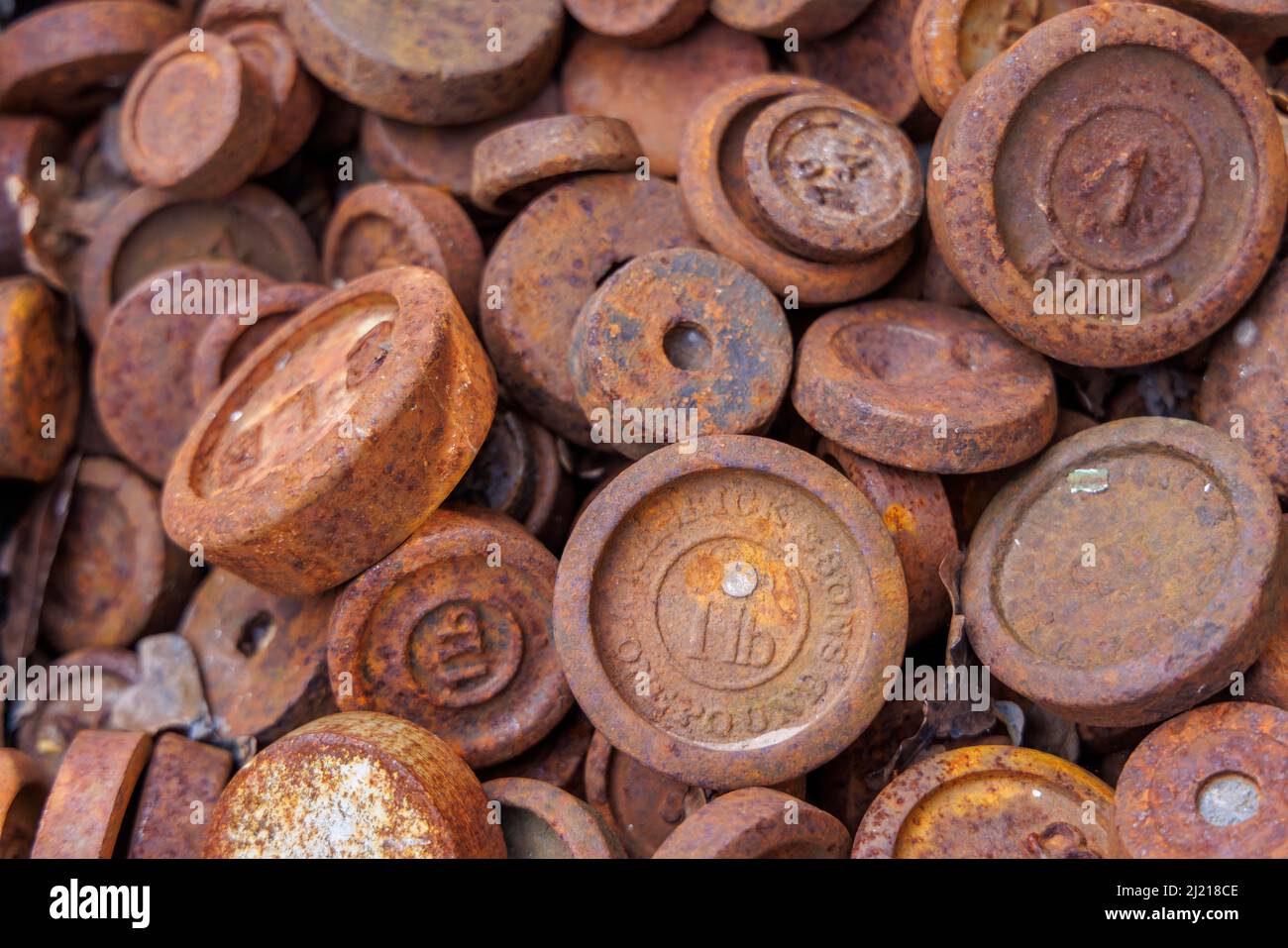 A collection of rusty imperial weights in an antique shop in Hungerford, a market town in Berkshire, south-west England Stock Photo