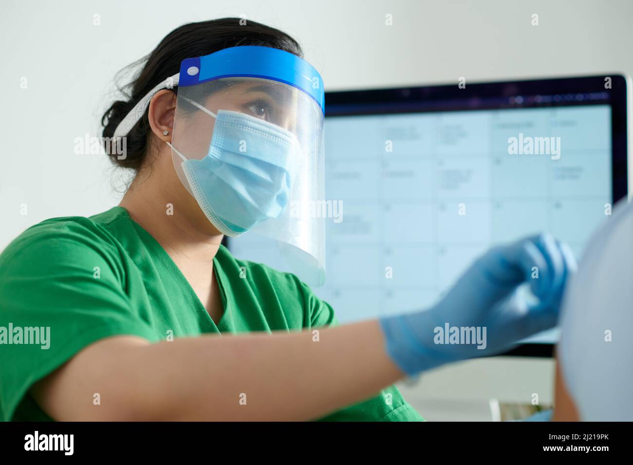 Shield Rn Serious nurse wearing protective face shield and medical mask when ...