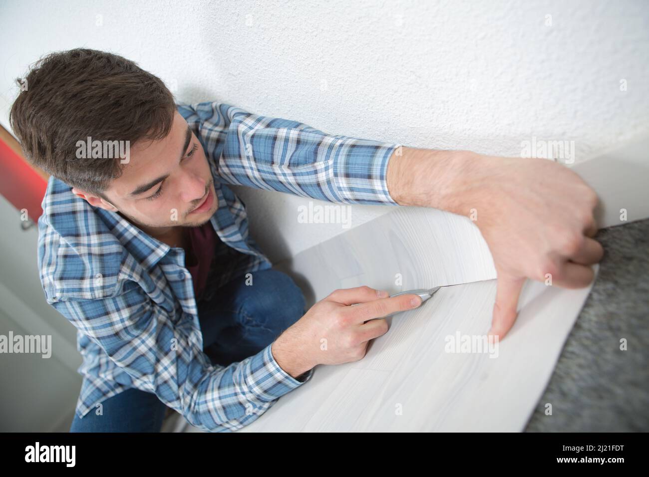 installing laminate flooring fitting the next piece Stock Photo Alamy
