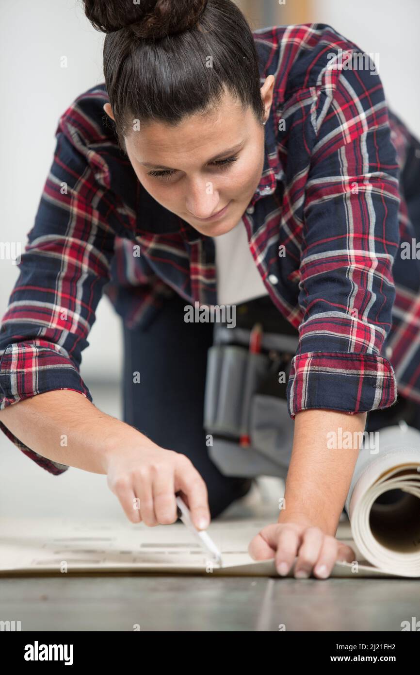 woman cutting a piece of carpet Stock Photo Alamy