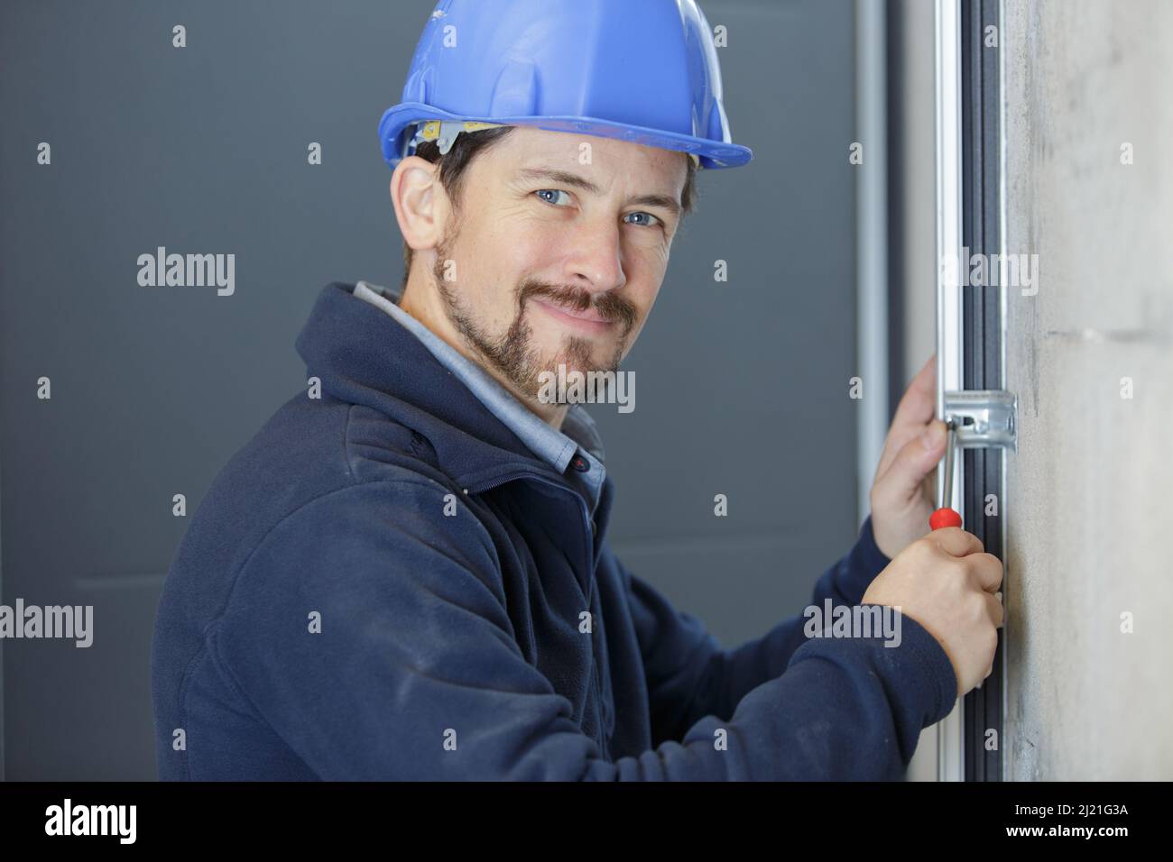 a male builder during window maintenance service Stock Photo