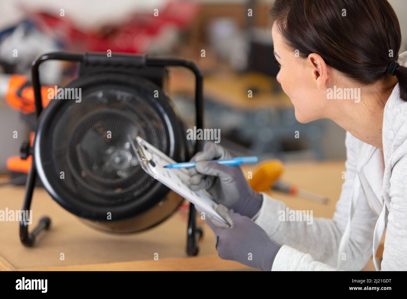 building inspector looking at light bulb Stock Photo - Alamy