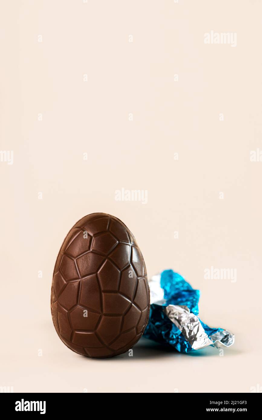 Happy Easter. Chocolate easter egg with copy space on light background Stock Photo
