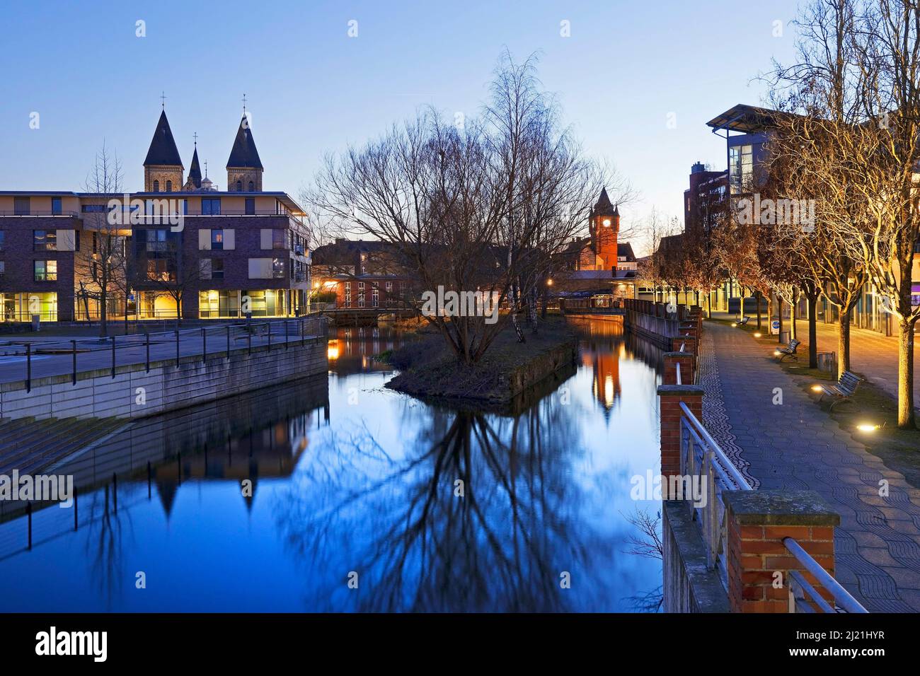 Church St. Antonius and old town hall tower with river Dinkel in the evening, Germany, North Rhine-Westphalia, Muensterland, Gronau Stock Photo