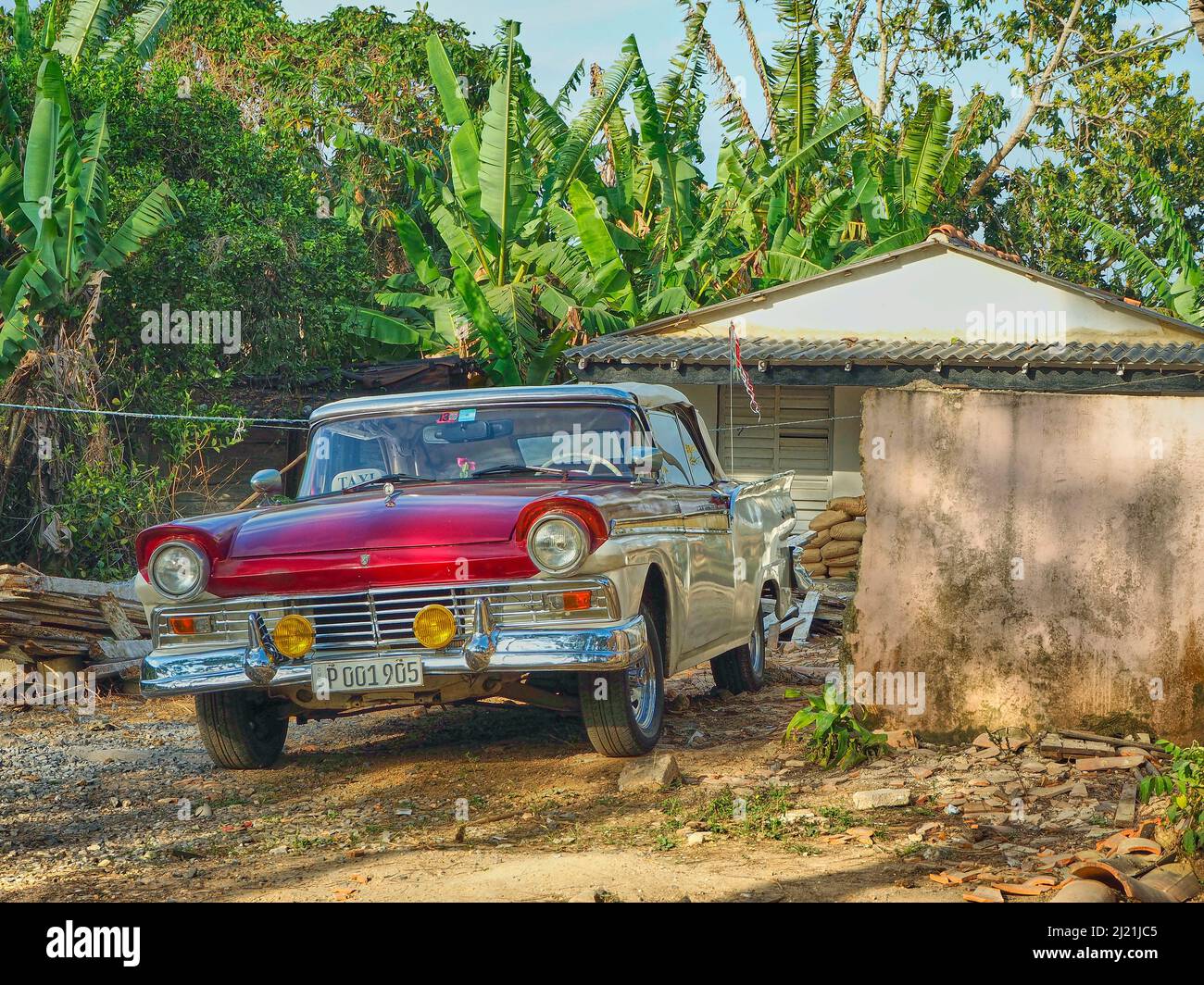 Vintage car taxi next to an old house, Cuba, Pinar del Rio, Vinales Stock Photo