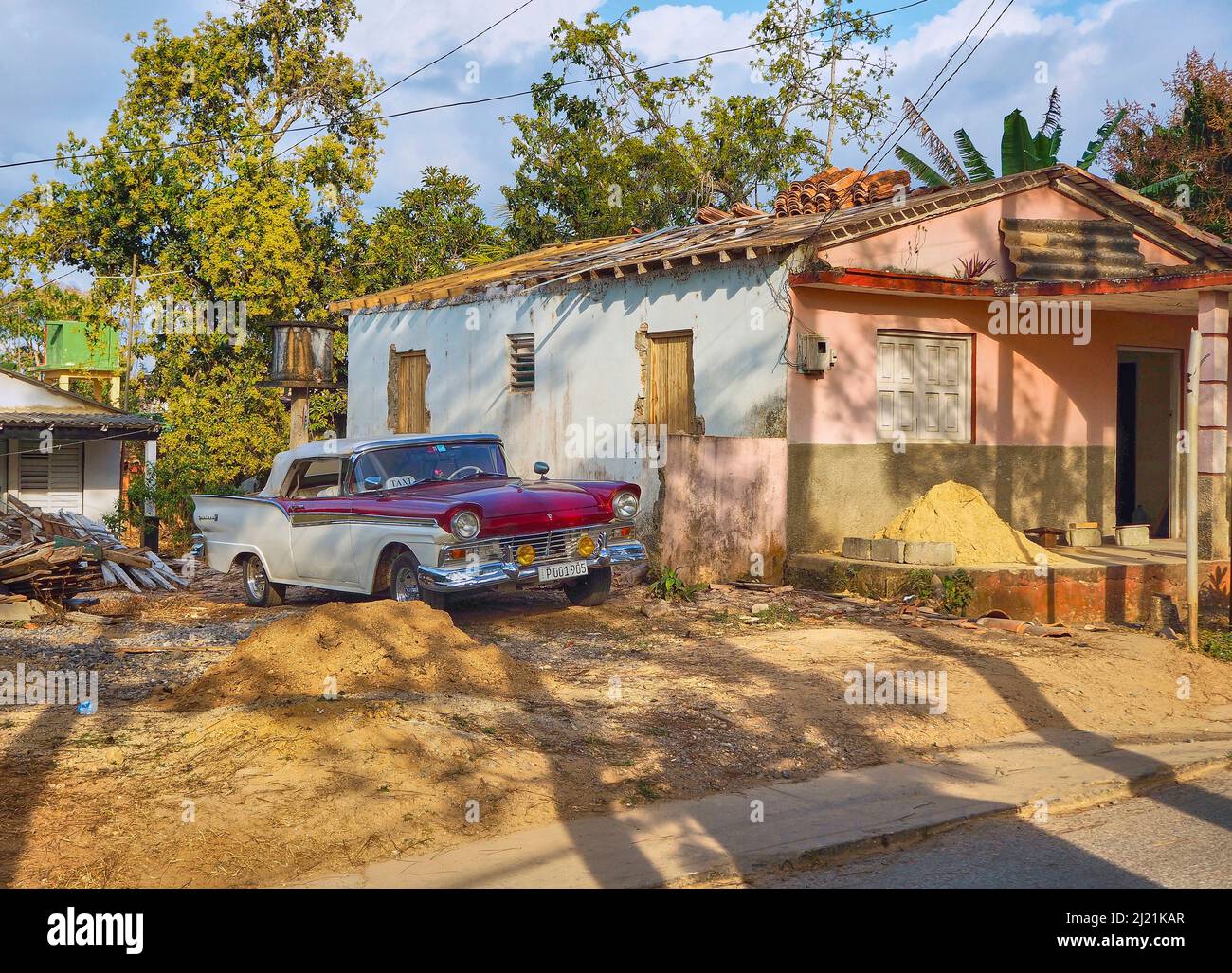 Vintage car taxi next to an old house, Cuba, Pinar del Rio, Vinales Stock Photo