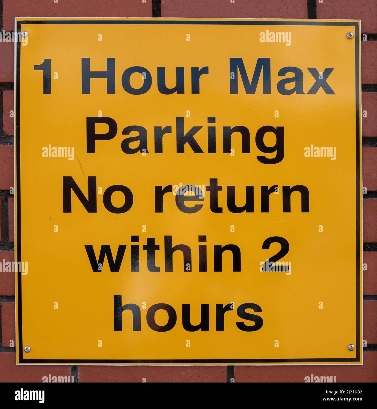 1 Hour Max Parking sign black text on yellow background Stock Photo
