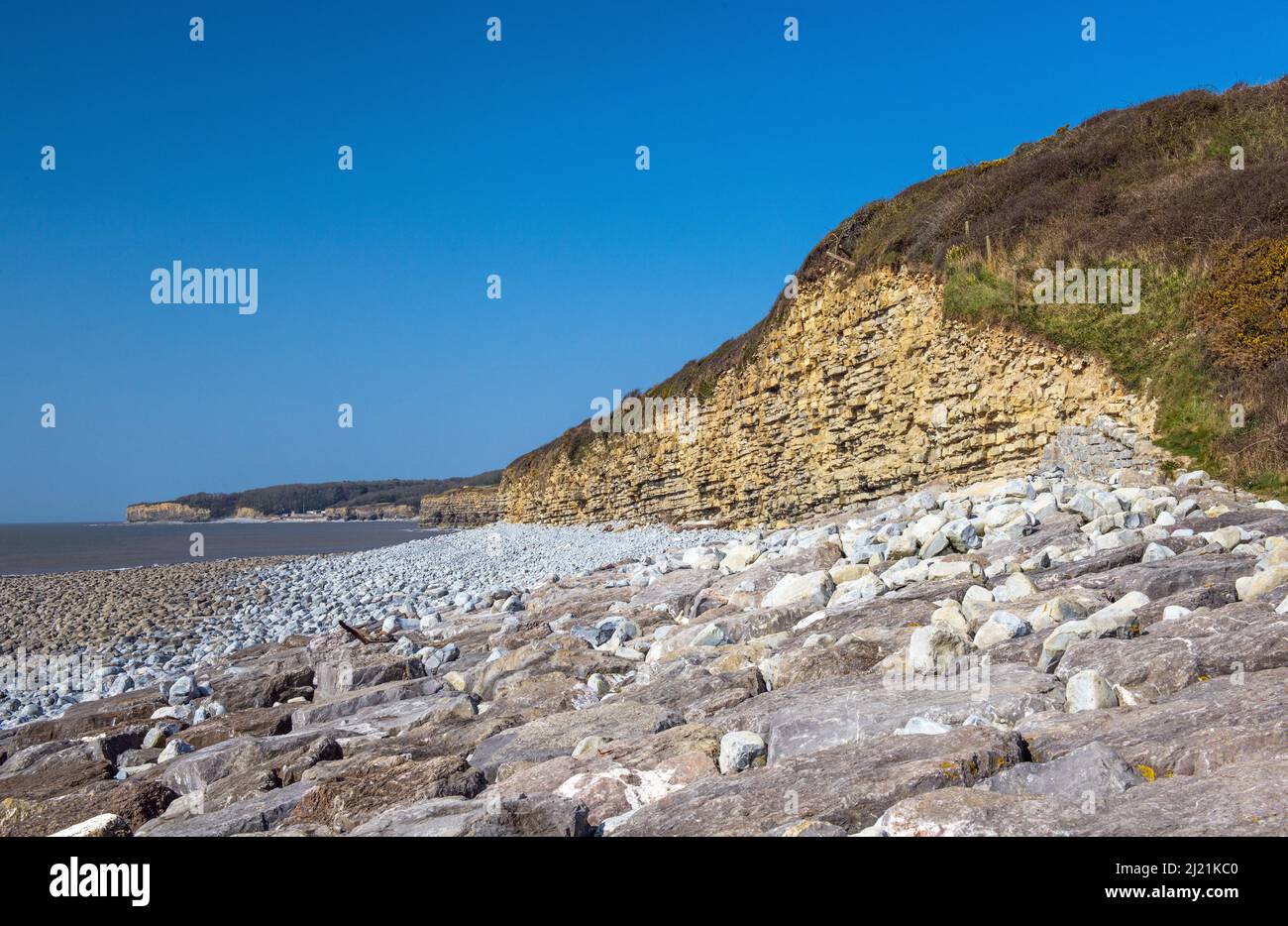 The view looking west along the coast towards St Donats Castle from Llantwit Major beach on the Glamorgan Heritage Coast Stock Photo