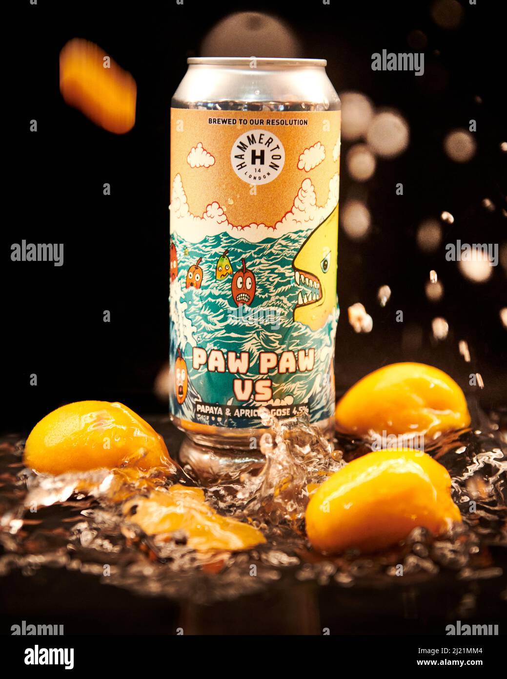A Can of Craft Beer in a water pool with peaches and movement to suggest a choppy sea in line with the art work. Stock Photo