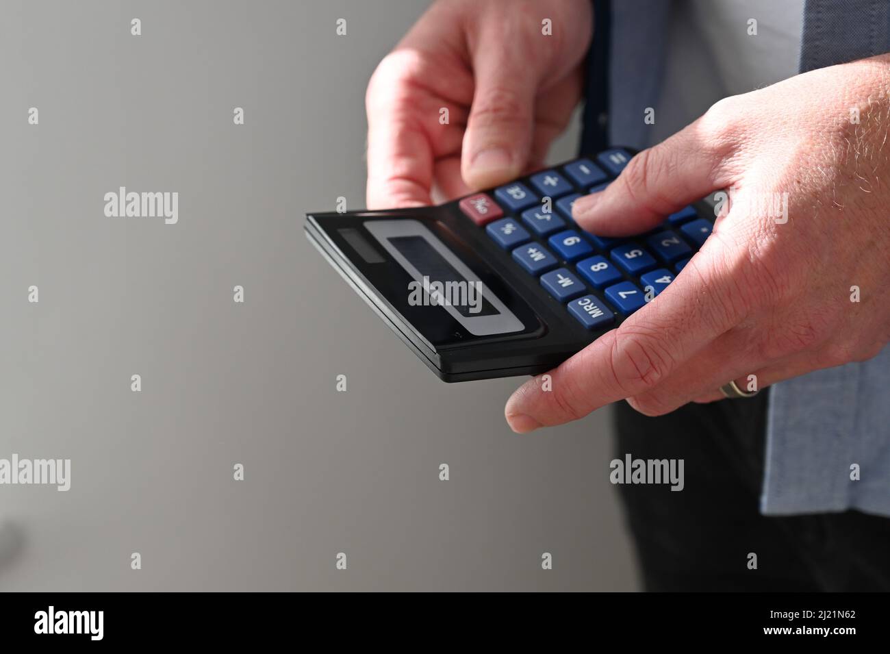 A man holding a calculator Stock Photo